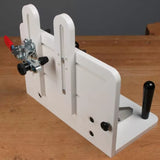 Woodworking tenoning jig with adjustable clamps on a wooden workbench