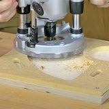 Plunge router cutting precise shapes in MDF wood with sawdust on workbench