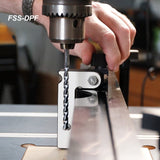 Drill press fence stop block in use with drill bit for accurate woodworking setups