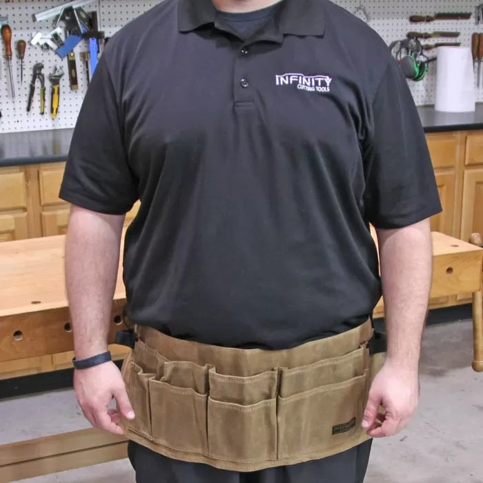 Canvas waist tool apron with multiple pockets worn by person in woodworking shop