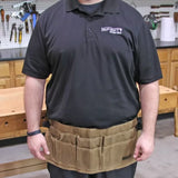 Canvas waist tool apron with multiple pockets worn by person in woodworking shop