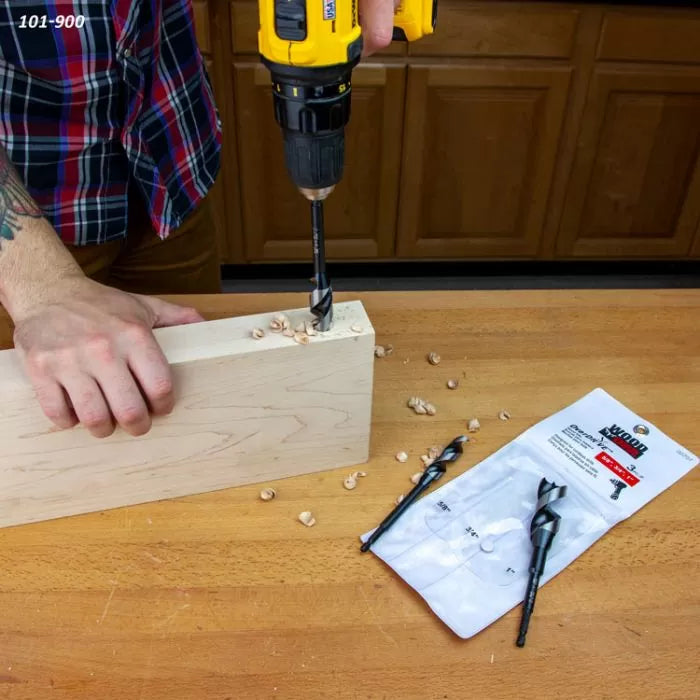 Person using a drill with a WoodOwl OverDrive bit to bore clean holes in a wood block