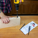 Person using a drill with a WoodOwl OverDrive bit to bore clean holes in a wood block
